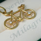 Dije Bicicleta con circón blanco en oro 18 quilates.