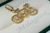 Dije Bicicleta con circón blanco en oro 18 quilates.